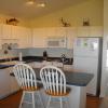 Well furnished kitchen with a eating bar.